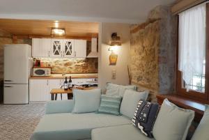 a living room with a couch and a kitchen at Martinis House in Pefkochori