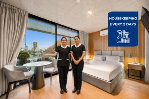a man and a woman standing in a hotel room at Live Soho Boutique Hotel & Apartments in Buenos Aires