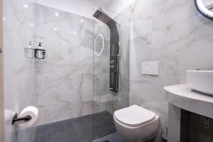 a bathroom with a shower and a toilet and a sink at Crystal Private Pool House in Artemida