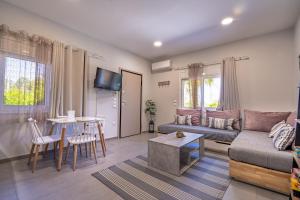 a living room with a couch and a table at Crystal Private Pool House in Artemida