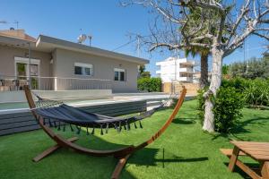 a hammock in a yard in front of a house at Crystal Private Pool House in Artemida +57 photos
