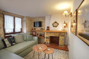 a living room with a couch and a fireplace at Martinis House in Pefkochori