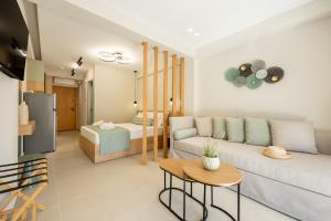 a living room with a couch and a table at MarAzul Luxury Suites in Flogita