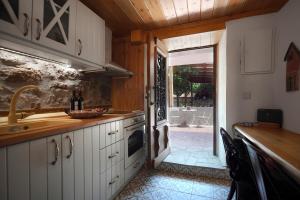 a kitchen with a sink and an open door at Martinis House in Pefkochori +25 photos