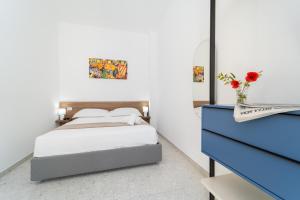 a bedroom with a bed and a blue dresser at Villa Gisa - Oasi Mediterranea in Calalunga-Pietragrande