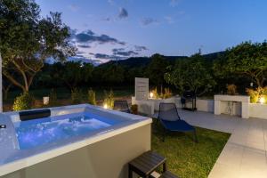 a jacuzzi tub on a patio at night at Villa Gisa - Oasi Mediterranea in Calalunga-Pietragrande