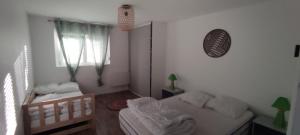 a small bedroom with a bed and a window at Appartement Saint Sulpice la Pointe in Saint-Sulpice
