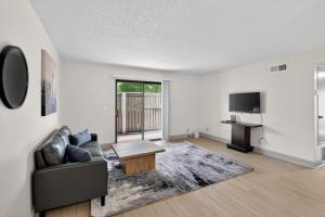 an empty living room with a couch and a table at Spacious 2BR stay with updated interiors in Lenexa