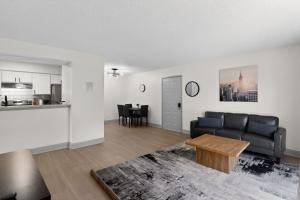 a living room with a couch and a table at Spacious 2BR stay with updated interiors in Lenexa