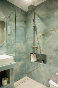 a bathroom with a shower and a sink at MarAzul Luxury Suites in Flogita +58 photos