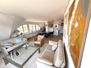 a living room with a couch and a table at FeWo Findling Ruegen in Putbus +14 photos