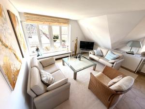 a living room with a couch and a table at FeWo Findling Ruegen in Putbus