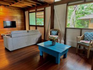 a living room with a couch and a table at Villas Serenidad in Puerto Viejo