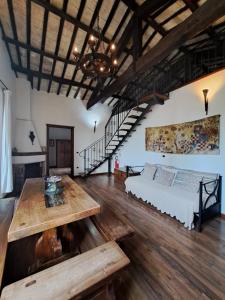 a room with a bed and a table and stairs at La dimora del ghibellino in Tivoli