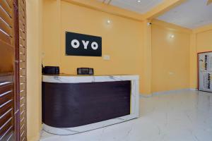 a large tv in a room with a sign on the wall at SPOT ON Galaxy Hotel in Lucknow