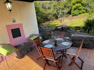 a table and chairs sitting on a patio at Casa Jardim 21 in Prazeres