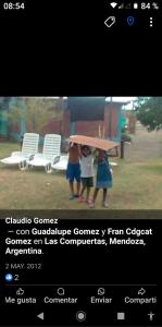 two people are standing under an umbrella at Pinkanta in Las Compuertas