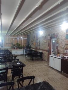 a restaurant with tables and chairs in a room at Anatolia Hotel in Pamukkale