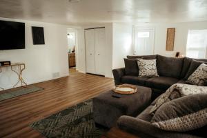 a living room with a couch and a table at Arminta Street Retreat in DuBois