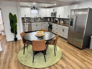 a kitchen with a table and chairs and a refrigerator at Arminta Street Retreat in DuBois