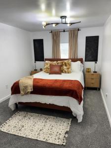 a bedroom with a large bed and a window at Arminta Street Retreat in DuBois