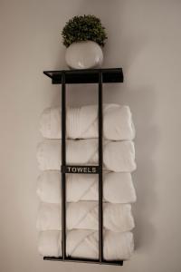 a black towel rack with towels on a wall at Arminta Street Retreat in DuBois +29 photos