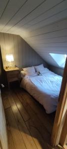 a dog laying on a bed in a room at Un gîte paisible et frais, piscine à 3 mins in Le Monteil