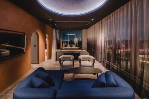 a living room with a blue couch and chairs at THE TSUBAKIMORI Hotel & Residence in Chiba +112 photos