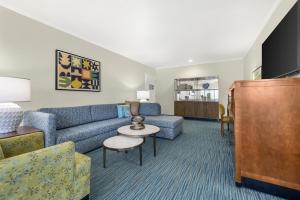 a living room with a couch and a table at Best Western Plus Beach View Lodge Carlsbad in Carlsbad