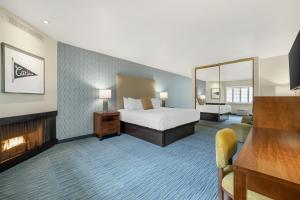 a hotel room with a bed and a large mirror at Best Western Plus Beach View Lodge Carlsbad in Carlsbad +52 photos