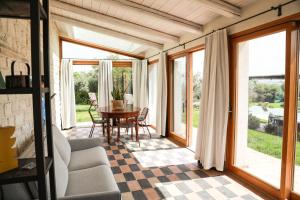 a living room with a table and glass doors at Casa Mansoor in Sirolo