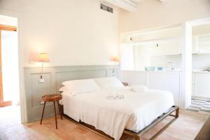 a white bedroom with a white bed and a table at Casa Mansoor in Sirolo +64 photos