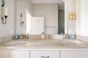 a bathroom with two sinks and a large mirror at King Bed, Beach Views, The Salt Surf Shack in Bolivar Peninsula +57 photos