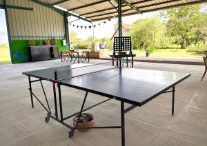 a ping pong table sitting inside of a building at La roulotte CIRCUS des Grillots in Beaulon