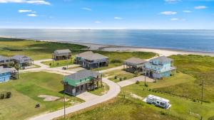 an aerial view of a house and the beach at King Bed, Beach Views, The Salt Surf Shack in Bolivar Peninsula