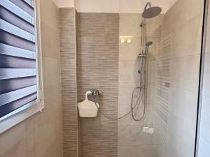 a shower with a shower head in a bathroom at Little Spyrela in Sinarádes +20 photos