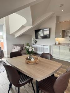 a kitchen and dining room with a table and chairs at Studio 7 in Dungannon