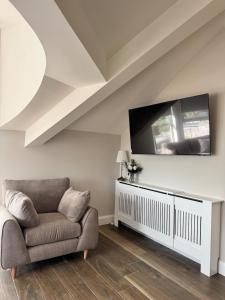 a living room with a couch and a flat screen tv at Studio 7 in Dungannon