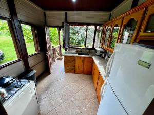 a kitchen with a white refrigerator and a stove at Annes Retreat in Castries +7 photos