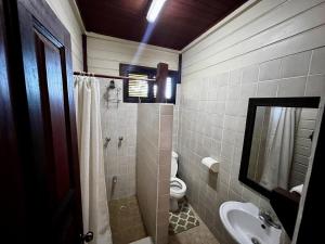 a bathroom with a shower and a toilet and a sink at Annes Retreat in Castries