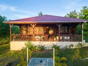 a wooden house with a red roof at Annes Retreat in Castries