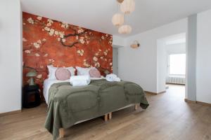 a bedroom with a bed with a floral wall at Maison chic avec Psicine - Talant proche Prenois in Talant +121 photos
