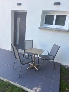 two chairs and a table on a patio at Studio moderne in Salles