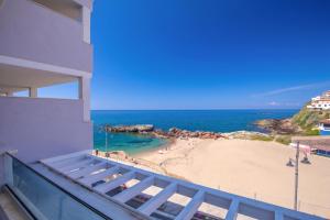 a balcony with a view of a beach at Hotel & SPA Riviera Castelsardo in Castelsardo