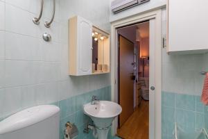 a small bathroom with a sink and a toilet at Blue Horizon Studio Opatija in Opatija +34 photos