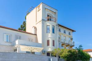 a large white building with a balcony at Blue Horizon Studio Opatija in Opatija