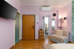 a room with a bed and a chair and a door at Blue Horizon Studio Opatija in Opatija