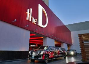 a limousine parked in front of a car dealership at The D Las Vegas in Las Vegas