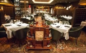 a restaurant with white tables and green chairs at The D Las Vegas in Las Vegas