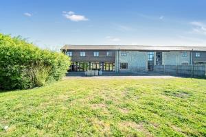 a building with a large yard in front of it at Converted Barn - Super King beds, Parking, WiFi in Hockwold cum Wilton